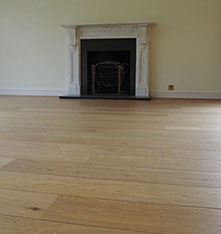 a picture of a wooden floor with a fire place 